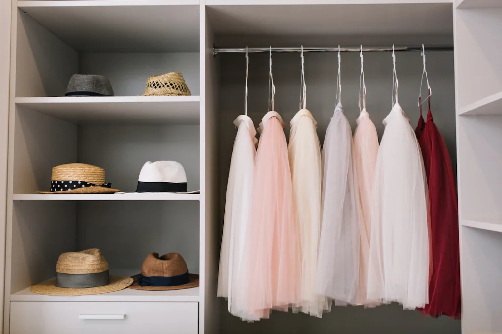 modern-bright-dressing-room-with-shelves-fashionable-hats-beautiful-pink-red-dresses-hanging-wardrobe_197531-1668